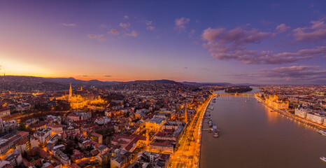 Aerial drone shot of lighted Matthias Churh Fisherman's Bastion on Buda Hill in Budapest sunset time