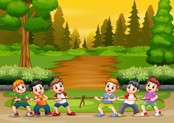 Group of boys playing tug of war in the park