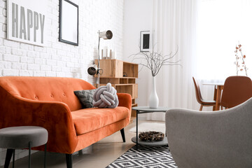 Fototapeta na wymiar Stylish interior of living room with comfortable sofa