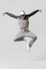 Male hip-hop dancer on light background