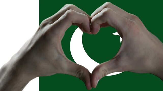 Hands showing Heart Sign over Pakistan Flag. 