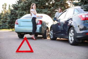 Emergency stop sign near broken cars after accident on road
