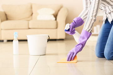 Young woman cleaning her flat