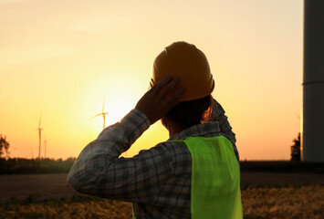 Male engineer on windmill farm for electric power production