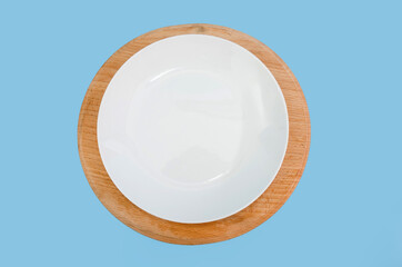 white plate on a blue background. View from above.