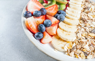 Delicious healthy breakfast of fruit salad with oat muesli. Dietary breakfast