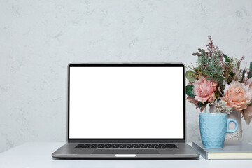 Fototapeta premium Laptop with blank empty screen on white table. Home interior. mockup