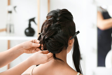 Hairdresser working with client in beauty salon