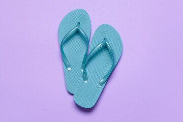 Stylish flip-flops on color background