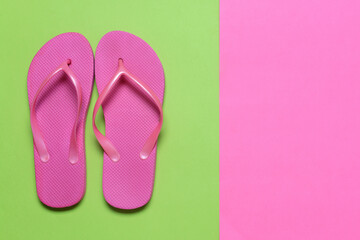Stylish flip-flops on color background