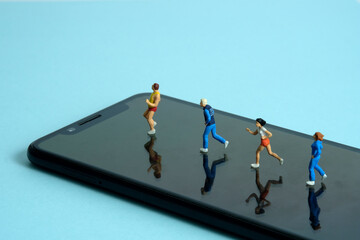 Running and jogging tracking app concept. A family running above smartphone. Miniature people...