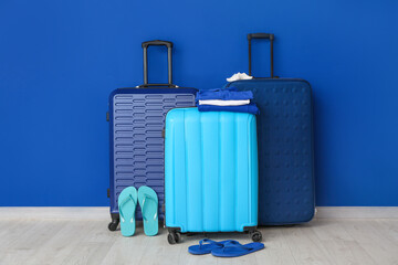 Packed luggage near color wall. Travel concept