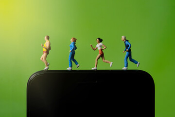 Running and jogging tracking app concept. A family running above smartphone. Miniature people...