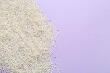 Heap of raw rice on color background