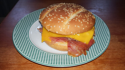 green white vintage plate with homemade tasty burger on wooden table