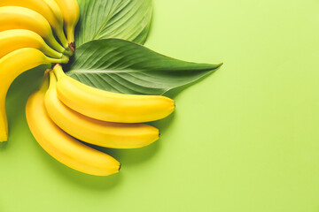 Ripe bananas on color background