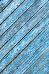 Blue color old wooden major diagonal planks with peeled paint background