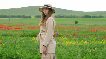 Girl in poppies field. Spring