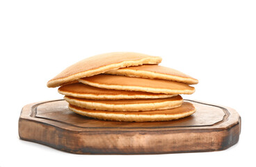 Board with tasty pancakes on white background