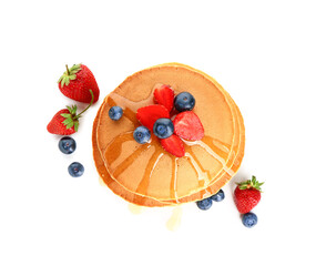 Sweet pancakes with berries on white background