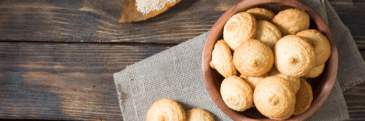 Shortbread in a wooden bowl on a brown wooden table. Top view with space for text. Banner