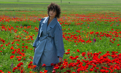 Girl in the poppy field. Spring