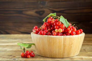 ripe red currants in a bamboo bowl.
