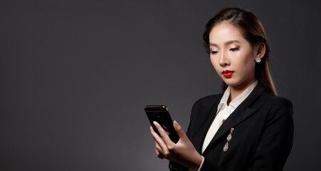 Naklejka premium Business woman wear suit touch digital screen smart phone copy space