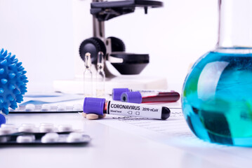 Naklejka premium Coronavirus 2019-nCoV concept still life with blood test, drugs and laboratory flasks. COVID-19 background.