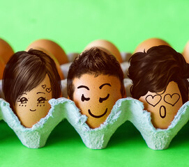 Faces on the eggs, One man with two women. Threesome or love triangle. Open relationship with polyamory, bigamy or polygamy. Intimacy between three people. Jealousy concept