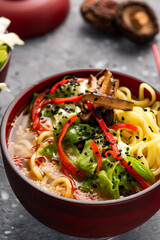 Ramen Soup Noodles in Decorative Bowl served with Fresh Vegetables. Clean Eating