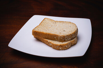 Homemade bread on a plate,Bread on a white plate placed on a wooden table