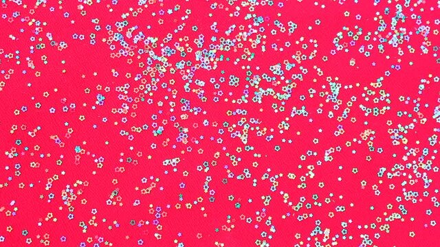 Multicolored shiny glitter confetti dots rain. Golden sparkling glittering border isolated on red background. Party tinsels shimmer, holiday background design, festive frame