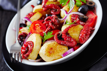 Restaurant dish baby octopuses with young potatoes