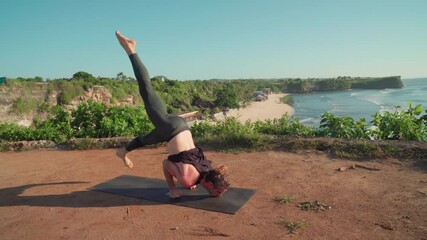Sequence of shots of male yogi doing sun salutation routine while practicing yoga on cliff overlooking ocean on sunny day on coast of Bali