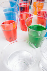 Plastic glass of colour and taste soda sparkling water. Red. Blue. Green. Orange.