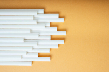 Background of white plastic straw in shape of music rhytm.