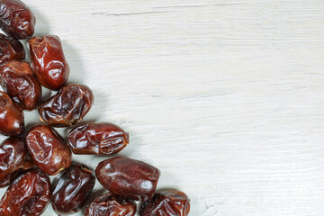 Dried dates on bleached wood, dried fruits.