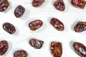 Dried dates on bleached wood, dried fruits.