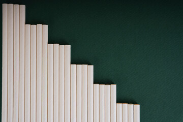 Fototapeta premium Top view - White straw over dark green background. Copy space.