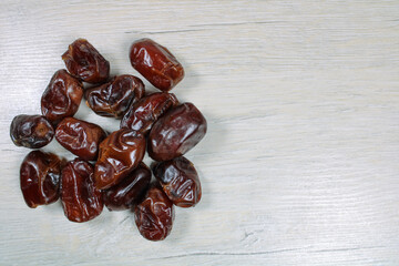 Dried dates on bleached wood, dried fruits.