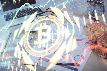 Double exposure of blockchain and crypto economy theme hologram and table with computer background. Concept of bitcoin cryptocurrency.