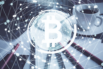 Multi exposure of blockchain and crypto economy theme hologram and table with computer background. Concept of bitcoin cryptocurrency.