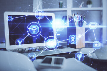 Computer on desktop with social network hologram. Double exposure. Concept of international people connections.