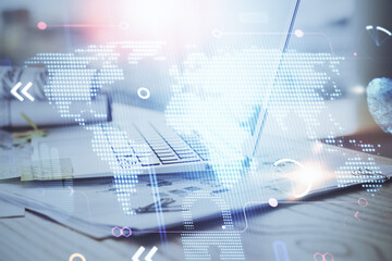 Multi exposure of table with computer and world map hologram. International data network concept.