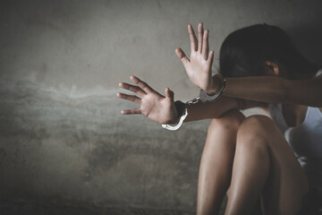 The victim was locked by handcuffs,  Human trafficking concept, Stop violence against Women, Women...