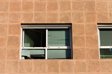 Rectangular windows of a modern building with terracotta walls (Pesaro, Italy, Europe)