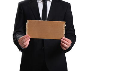 A man in a suit holds a cardboard poster on a white background. Business concept bankruptcy, poverty, failure