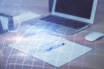 Multi exposure of table with computer and world map hologram. International data network concept.