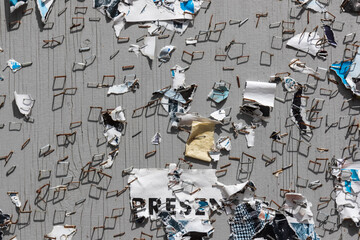 remnants of leaflets and posters on a board, with only staples and pieces of torn paper
